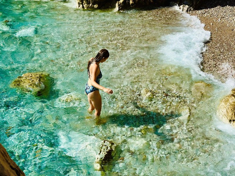 A guest wading in clear water