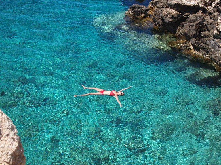 A swimmer in a nearby lagoon
