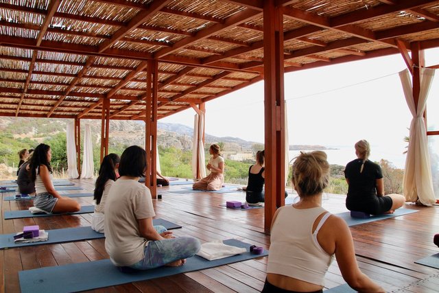 A group practicing in the sea-view yoga shala