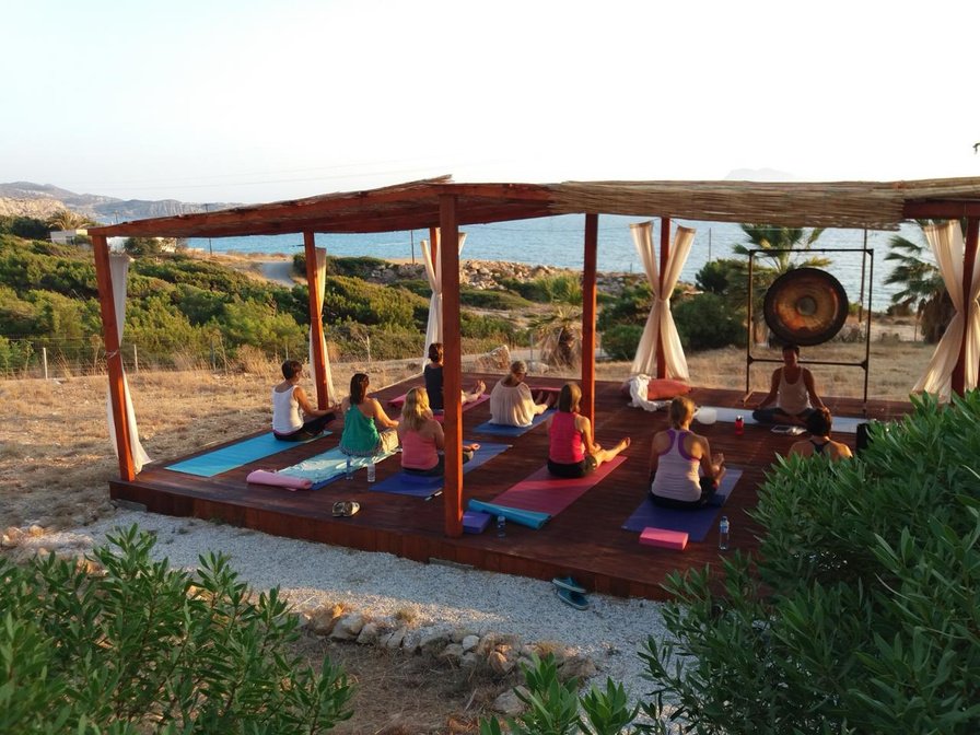 Group yoga practice in an outdoor shala